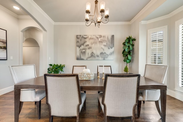 5 Maltese Cir, Heath, TX 75032 - dining area featuring baseboards, wood finished floors, a chandelier, arched walkways, and crown molding