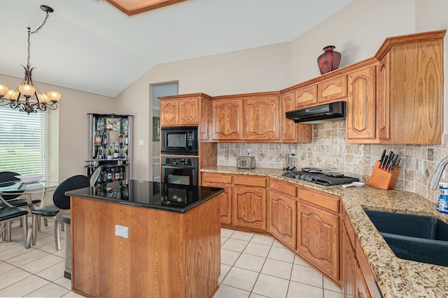 kitchen with black appliances, under cabinet range hood, a sink, light tile patterned floors, and vaulted ceiling