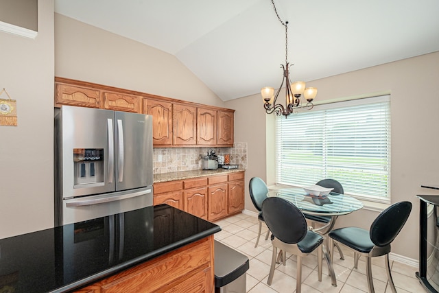 kitchen featuring stainless steel fridge, light tile patterned flooring, decorative backsplash, lofted ceiling, and hanging light fixtures