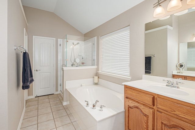 full bathroom featuring a stall shower, a bath, tile patterned flooring, vanity, and vaulted ceiling