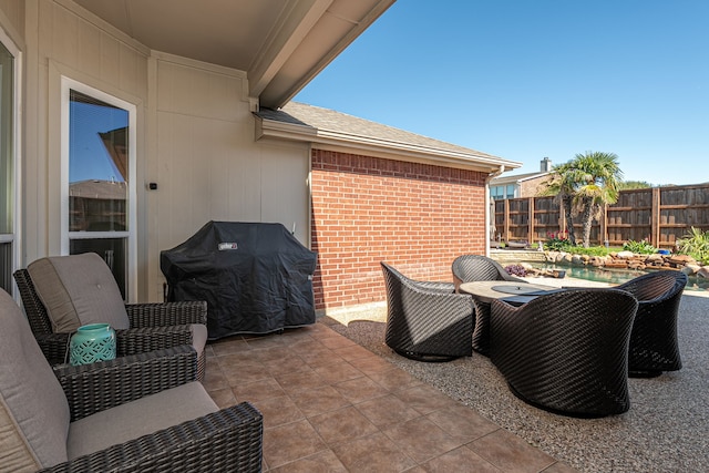 view of patio featuring grilling area and fence