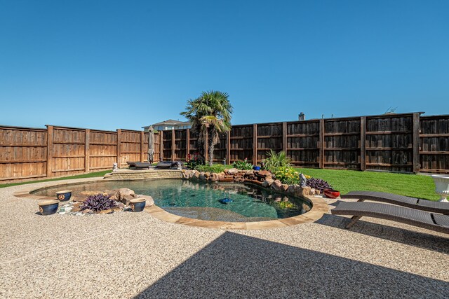 view of pool with a patio and a fenced backyard