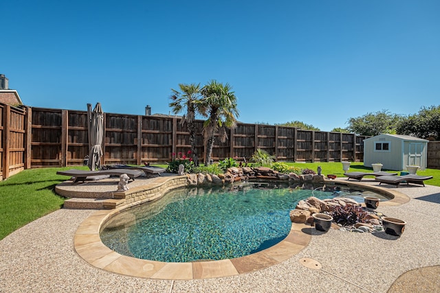 view of pool with a shed, an outbuilding, and a patio