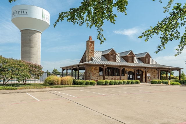 view of property featuring fence and uncovered parking