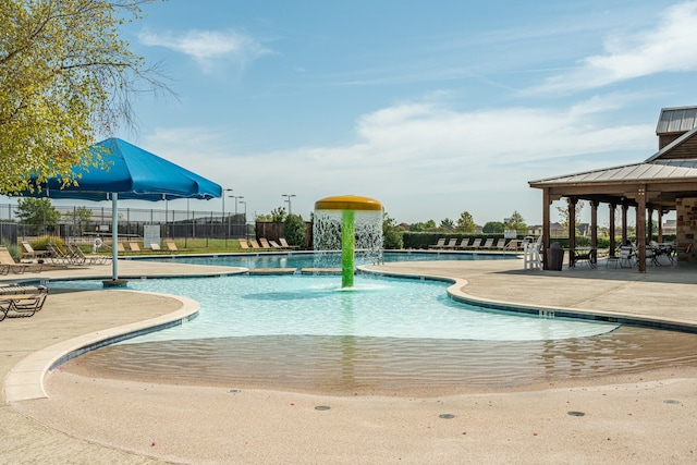 community pool with fence, a patio area, and a gazebo