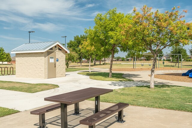 view of community featuring an outbuilding, a storage unit, and a lawn