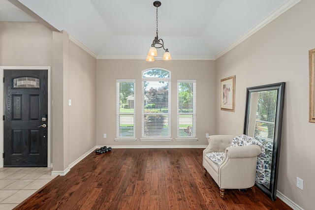 unfurnished room featuring wood finished floors, a chandelier, baseboards, and vaulted ceiling