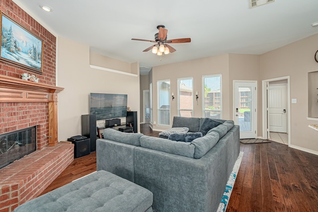 living room with dark wood finished floors, ceiling fan, a fireplace, baseboards, and recessed lighting