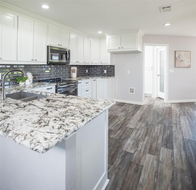 102 Camino Real W, Wylie, TX 75098 - kitchen featuring appliances with stainless steel finishes, a sink, white cabinets, light stone counters, and backsplash