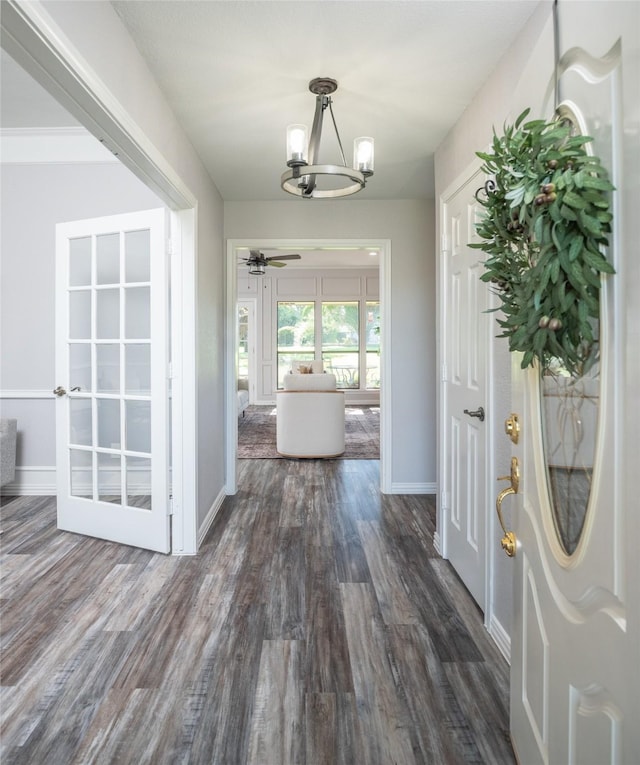 102 Camino Real W, Wylie, TX 75098 - hall featuring a chandelier, dark wood finished floors, and baseboards
