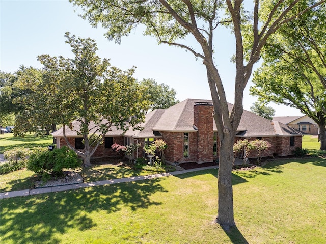 102 Camino Real W, Wylie, TX 75098 - view of front of home featuring brick siding, a front lawn, and a shingled roof