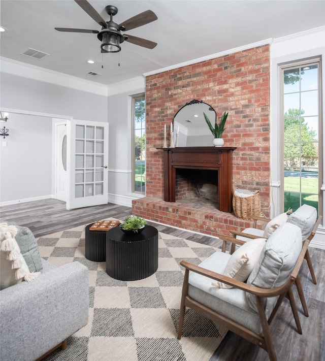 102 Camino Real W, Wylie, TX 75098 - living room with crown molding, baseboards, plenty of natural light, wood finished floors, and ceiling fan