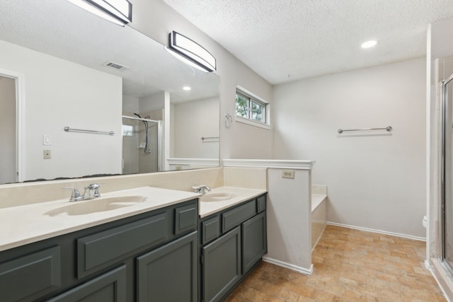 3516 Napolean Ct, Plano, TX 75023 - bathroom with a shower stall, double vanity, a textured ceiling, recessed lighting, and a garden tub