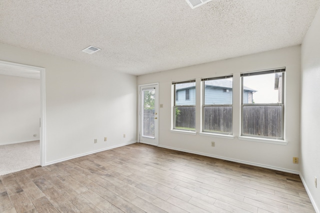 3516 Napolean Ct, Plano, TX 75023 - spare room featuring wood finished floors, a textured ceiling, and baseboards