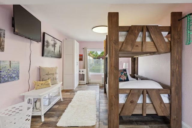 bedroom featuring wood finished floors and baseboards