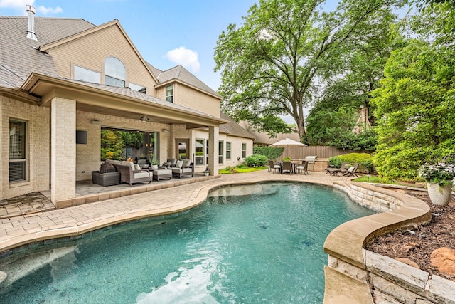 outdoor pool with an outdoor living space, a patio area, outdoor dining area, fence, and ceiling fan