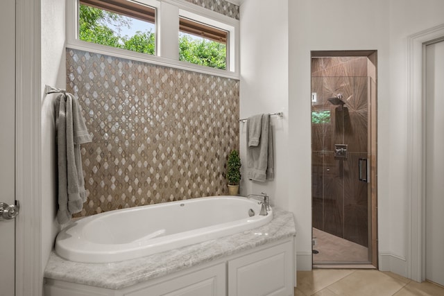 full bath with a shower stall, a garden tub, and tile patterned flooring