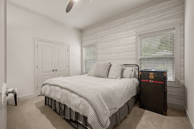 bedroom featuring carpet, baseboards, a closet, and ornamental molding