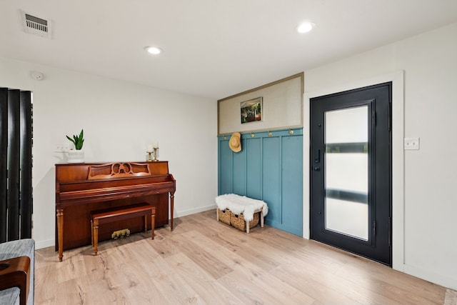 foyer entrance featuring light wood-style flooring and recessed lighting