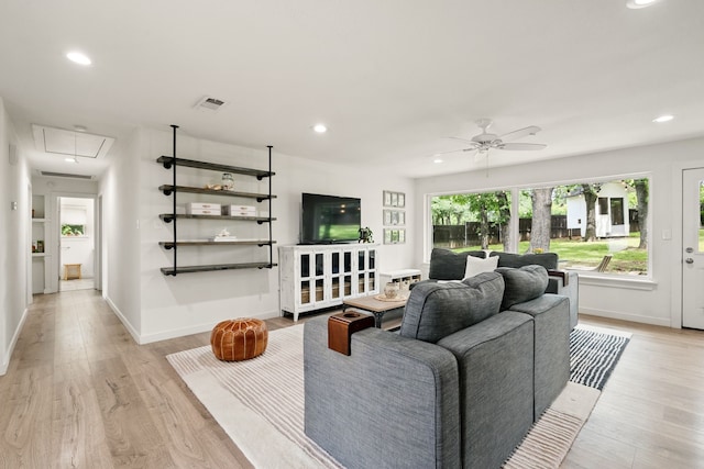 living room featuring attic access, light wood-type flooring, recessed lighting, ceiling fan, and baseboards