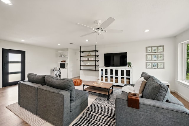 living room with wood finished floors, recessed lighting, a ceiling fan, and baseboards