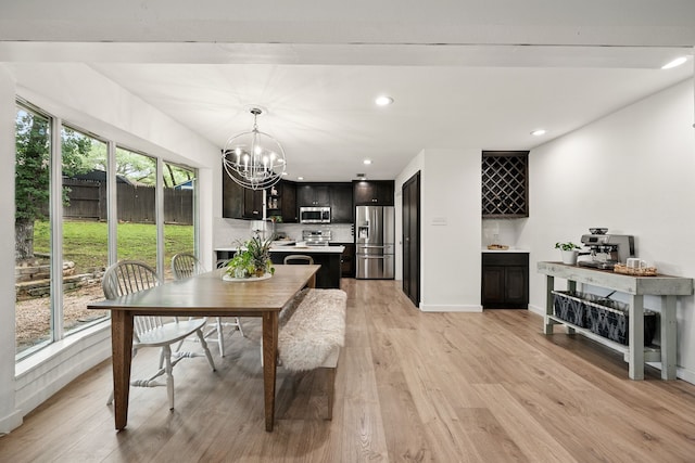 dining room with a chandelier, light wood-type flooring, recessed lighting, and baseboards