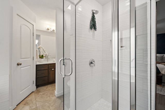 full bathroom with a shower stall and vanity