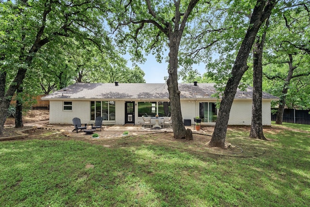 rear view of house featuring brick siding and a patio area