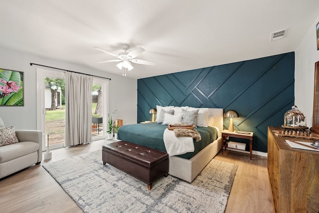 bedroom with access to outside, wood finished floors, and a ceiling fan