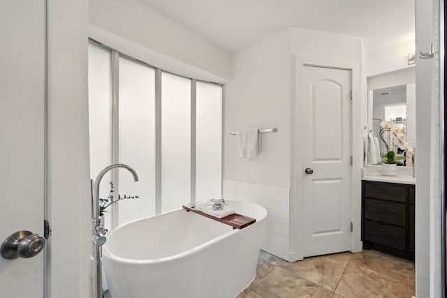 bathroom featuring a freestanding bath and vanity
