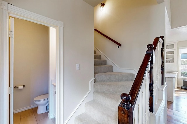 stairs with tile patterned floors and baseboards