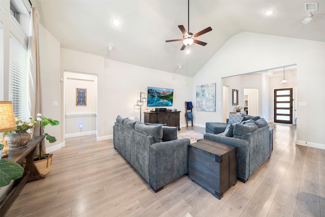 living room with a ceiling fan, light wood-type flooring, high vaulted ceiling, healthy amount of natural light, and recessed lighting