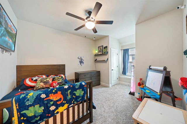 carpeted bedroom featuring a ceiling fan, baseboards, and vaulted ceiling