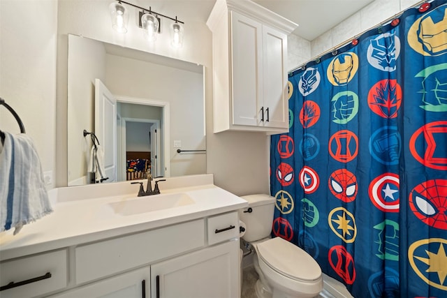 bathroom with toilet, vanity, and a shower with shower curtain