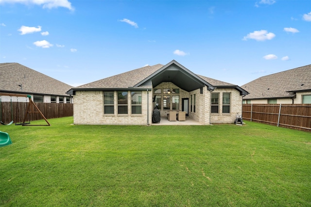 back of house featuring a patio, brick siding, a ceiling fan, a playground, and roof with shingles