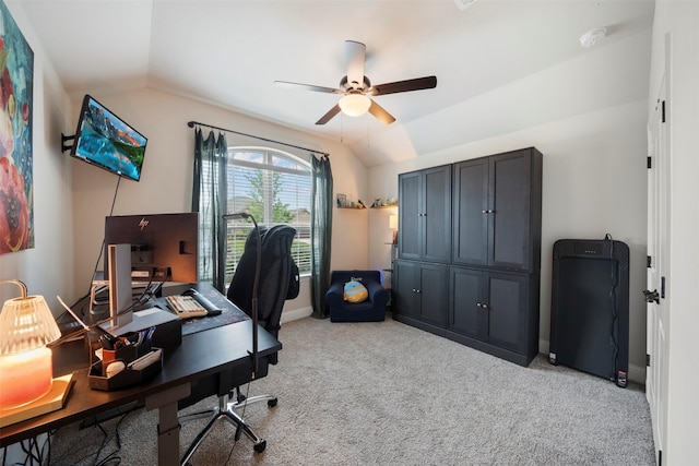 home office with lofted ceiling, ceiling fan, light carpet, and baseboards