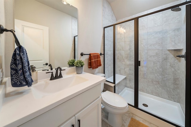 full bath with a stall shower, toilet, and vanity