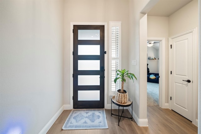entryway featuring wood finished floors and baseboards