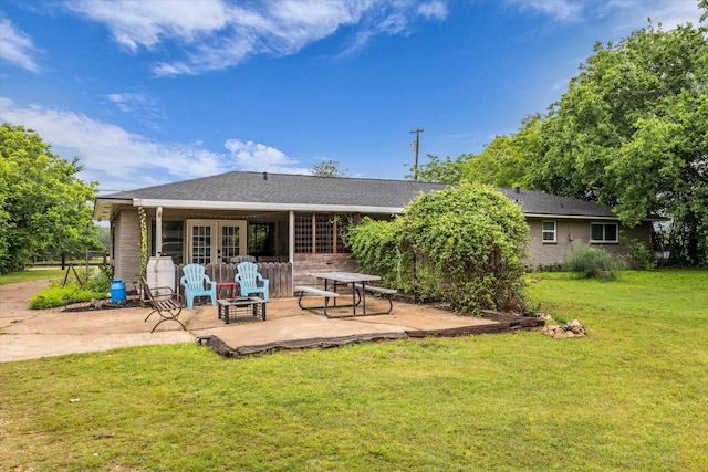 3601 Orchard Ln, Waco, TX 76705 - rear view of property featuring a patio, a lawn, french doors, and an outdoor fire pit