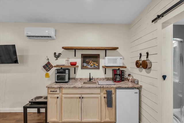 3601 Orchard Ln, Waco, TX 76705 - kitchen with an AC wall unit, white microwave, a sink, open shelves, and fridge