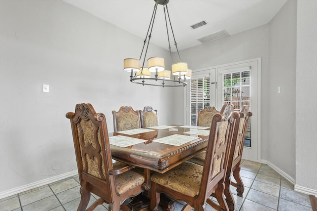 dining room featuring baseboards, a chandelier, and light tile patterned flooring