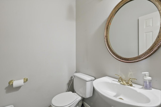 half bathroom with a sink and toilet