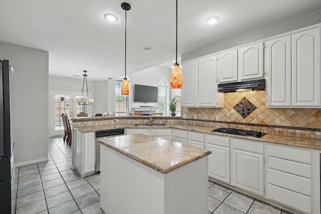kitchen featuring gas cooktop, stainless steel dishwasher, under cabinet range hood, a sink, and a peninsula
