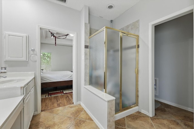 bathroom featuring a shower stall, vanity, connected bathroom, and baseboards