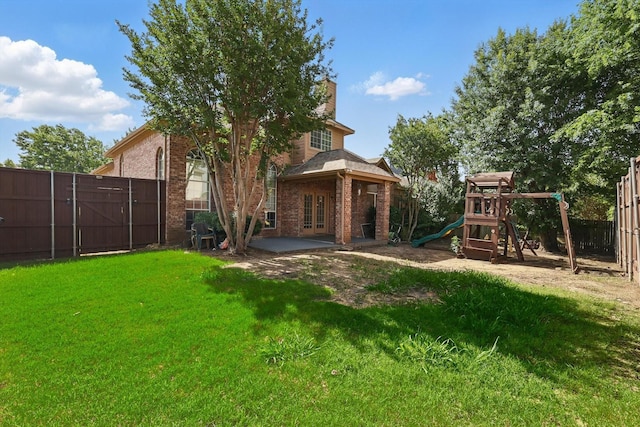view of yard featuring a playground, a patio, and french doors