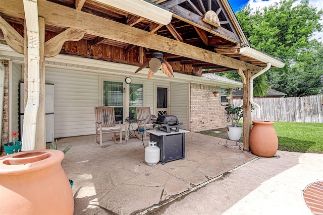view of patio featuring fence and ceiling fan