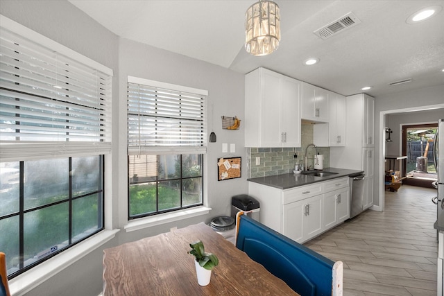 4677 Bracken Dr, Fort Worth, TX 76137 - kitchen featuring a sink, backsplash, white cabinetry, recessed lighting, and dark countertops