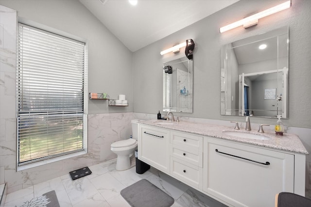 4677 Bracken Dr, Fort Worth, TX 76137 - bathroom with marble finish flooring, vaulted ceiling, a marble finish shower, double vanity, and tile walls