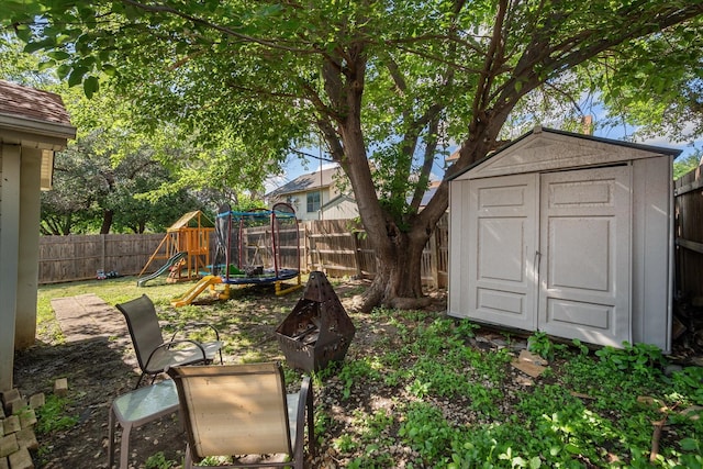 4677 Bracken Dr, Fort Worth, TX 76137 - fenced backyard featuring a storage unit, a playground, and an outdoor structure