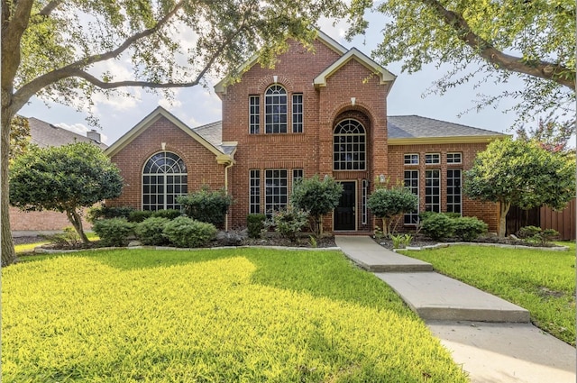 8431 Firewheel Ln, Frisco, TX 75036 - traditional home with brick siding, a front lawn, and a shingled roof